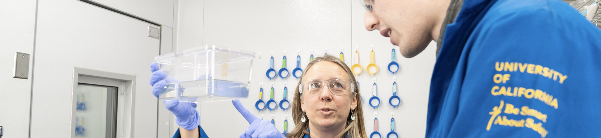 two scientists in blue coats